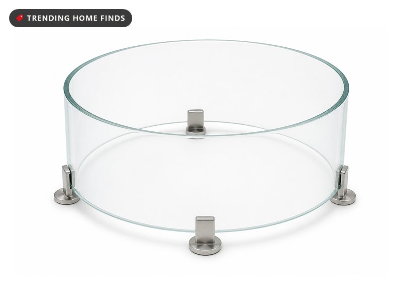 A short round cylinder of clear tempered glass standing on four small metal feet.
