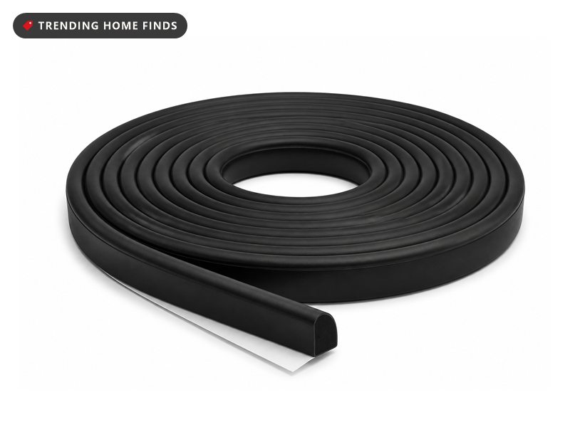 A coiled roll of black self adhesive door seal strip with its loose end pulled straight.