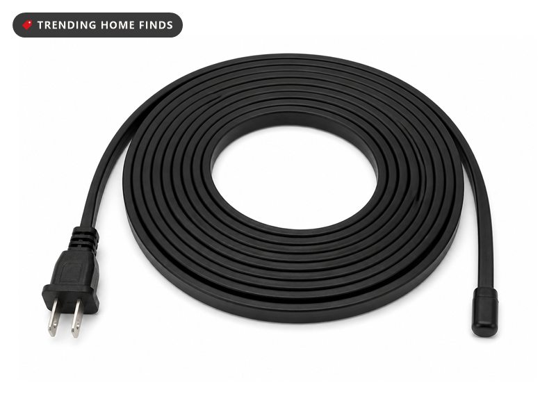 A black self regulating pipe heating cable in a loose coil with a flat two blade plug at one end and a sealed cap at the other.