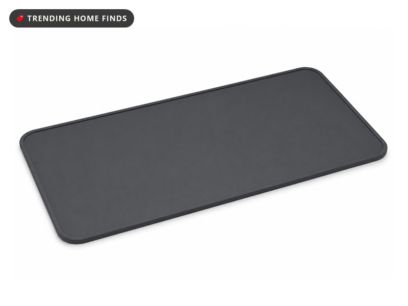 A long flat charcoal silicone food warming mat with rounded corners.
