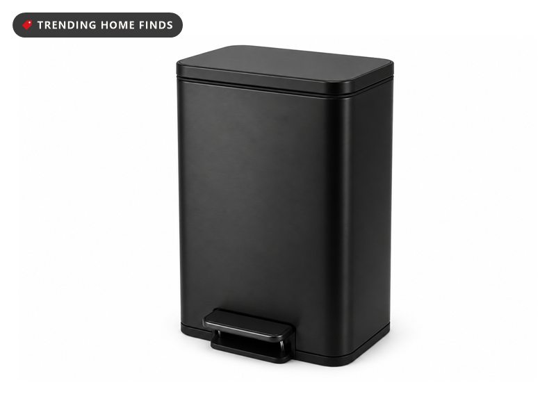 A slim matte black stainless steel step trash can with a flat lid and a small foot pedal.