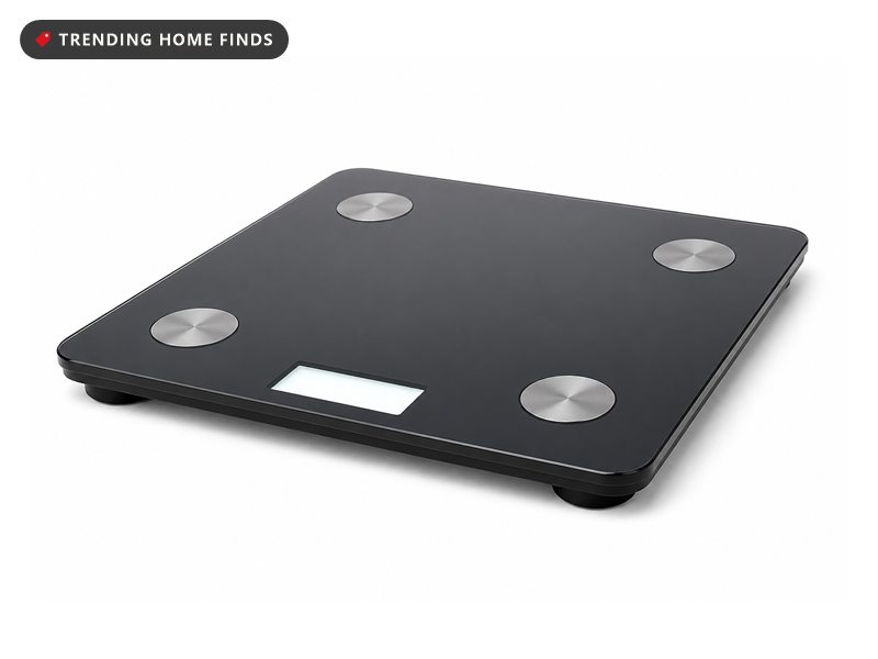 A low black smart scale with a tempered glass top and four round sensing pads.