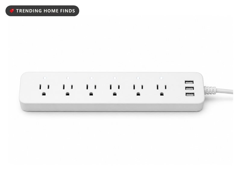 A white smart power strip with six outlets in a row, status lights and three USB ports.