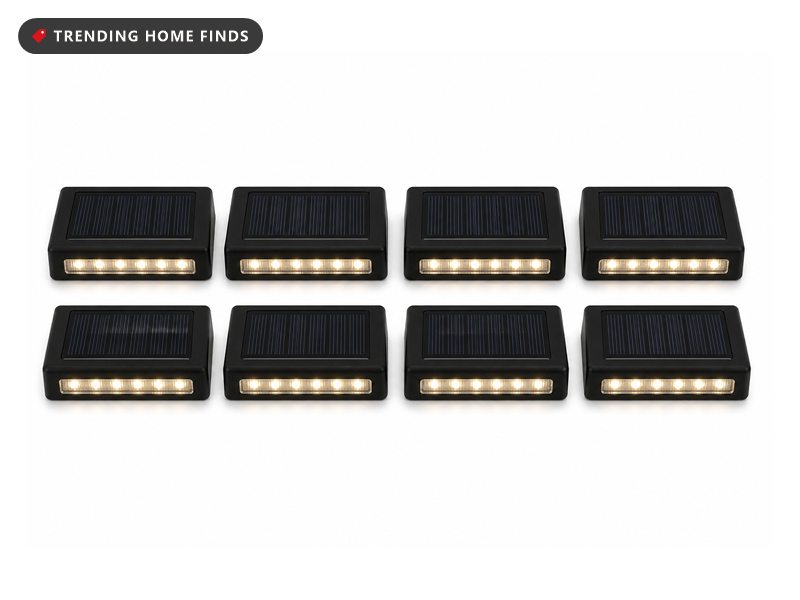 Eight small flat black solar lights, each with a solar panel on top and warm white LEDs on the front.