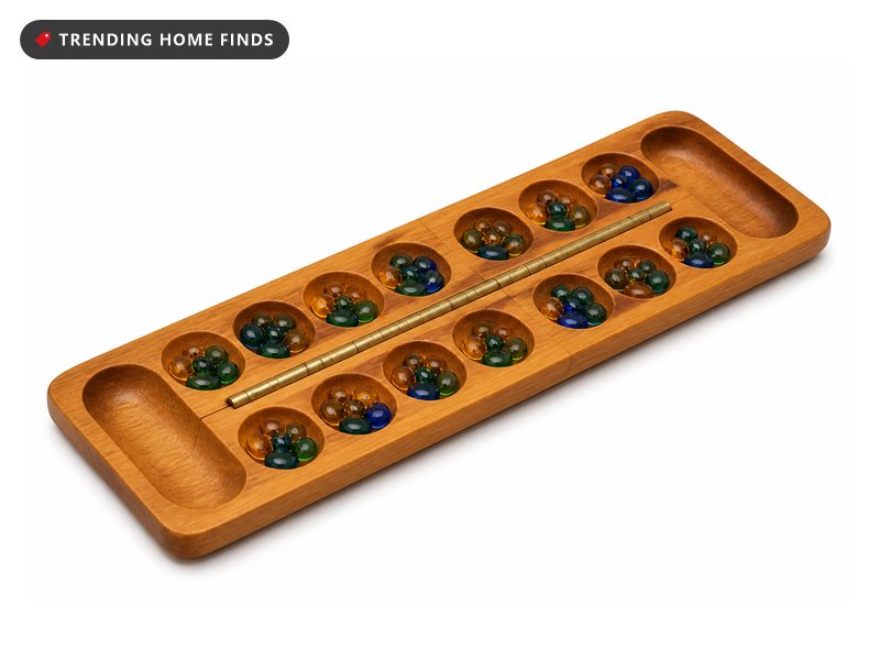 An open folding solid wood mancala board with two rows of shallow cups and colored glass stones.