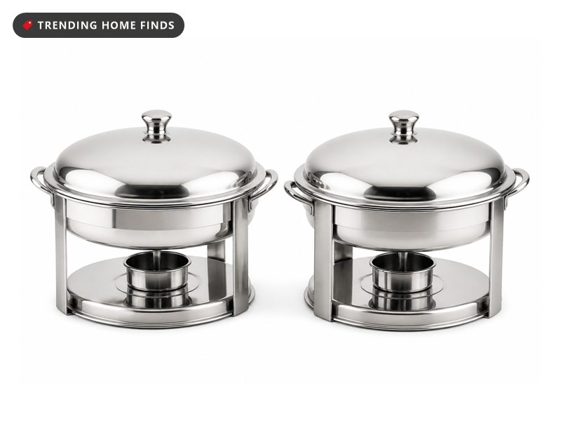 Two round polished stainless steel chafing dishes on round stands, each with a domed lid and a fuel holder underneath.