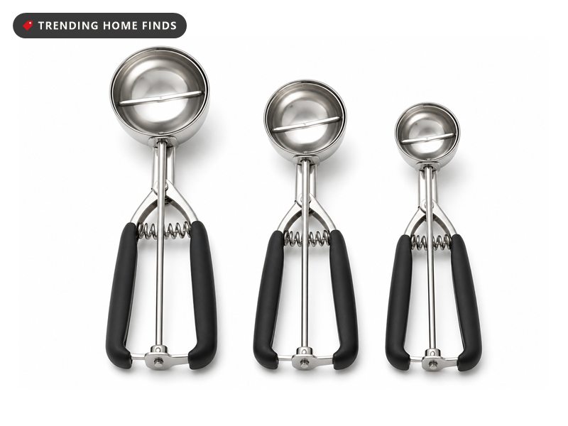Three stainless steel cookie scoops in three sizes with squeeze trigger handles and black grips.