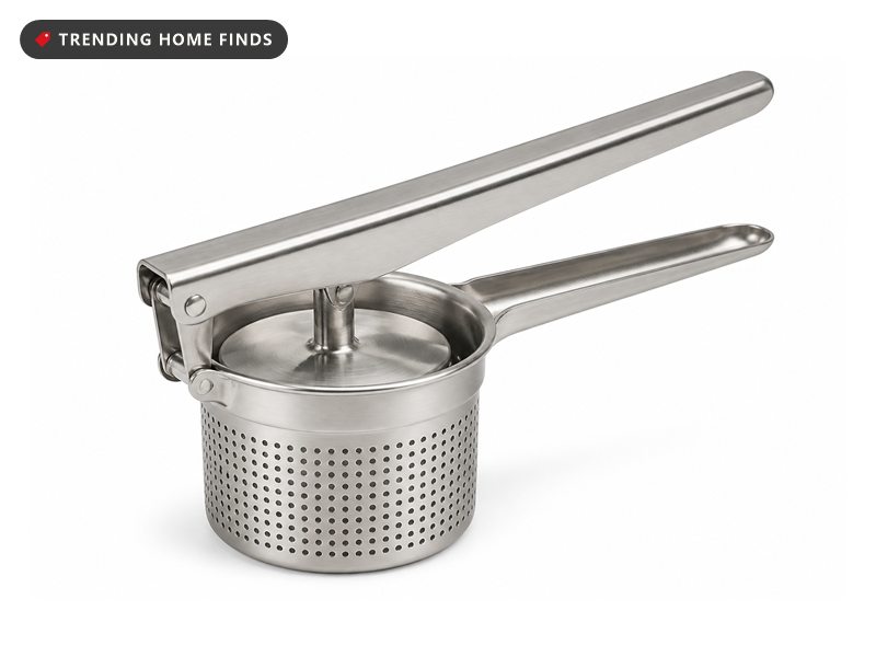 A heavy stainless steel potato ricer with a round perforated basket, a flat plunger and two long hinged handles.