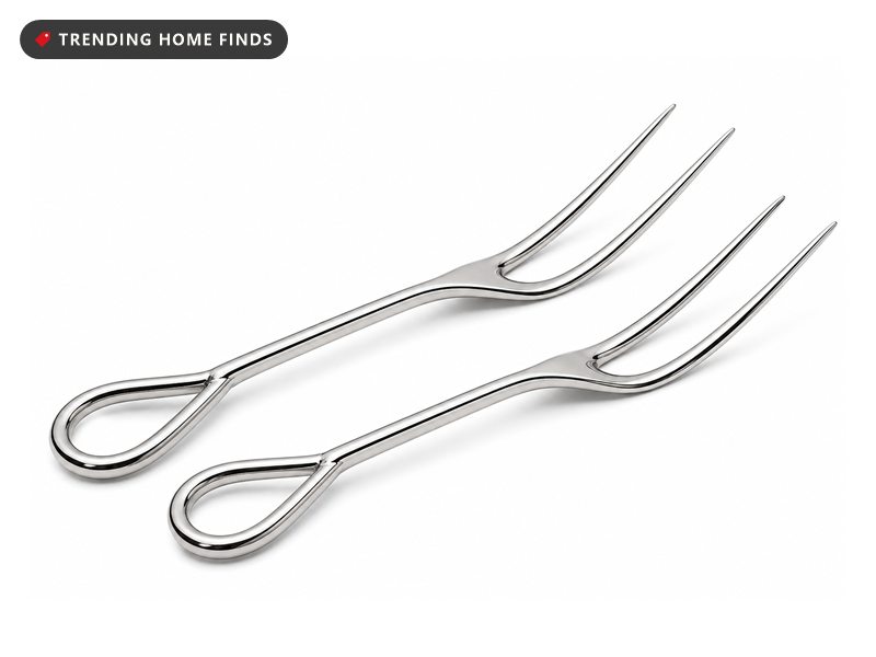 Two polished stainless steel turkey lifter forks, each with two long curved tines and a looped handle.