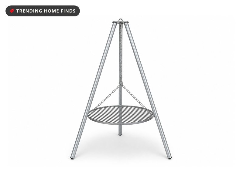 A steel tripod campfire grill with three straight legs and a round grate hanging from a chain.
