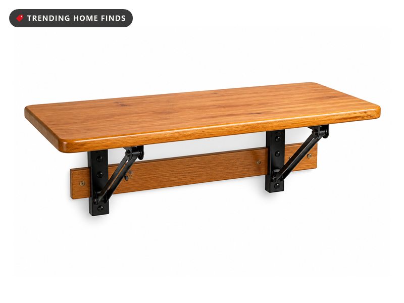 A wall mounted folding workbench with a glossy wood top and powder coated steel brackets, folded down.