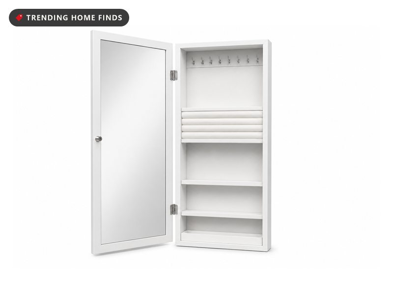 A tall slim white jewelry cabinet with its mirrored door open to hooks, ring slots and shelves.
