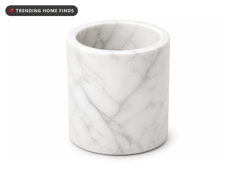 A plain white marble cylinder with soft gray veining, open at the top.