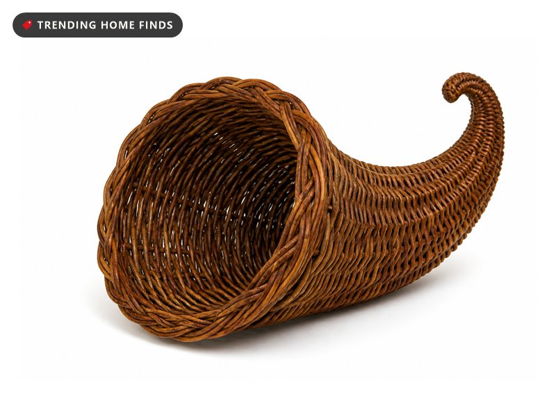 A curved woven grapevine wicker cornucopia horn, open at one end and curled to a point at the other.