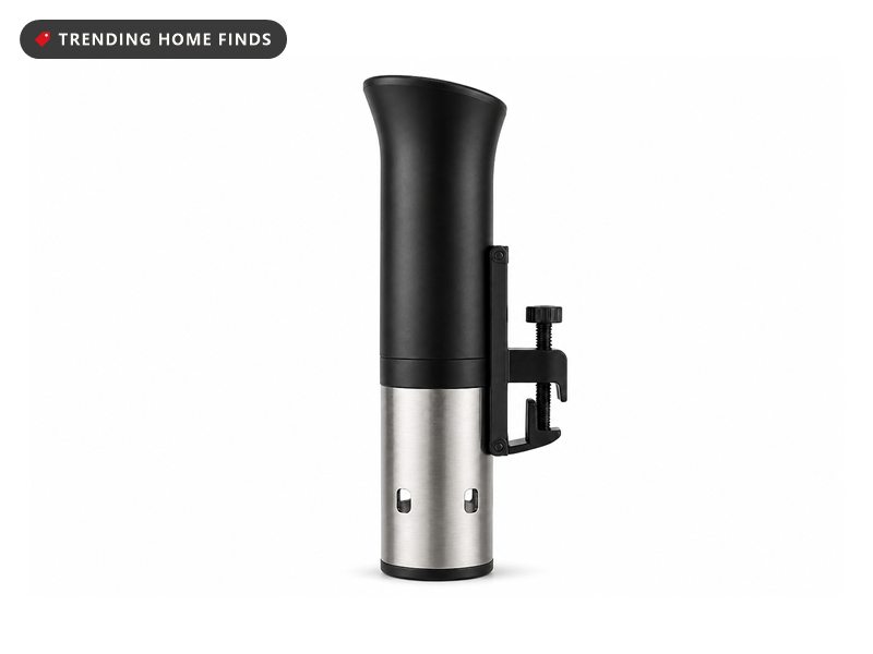 A slim black and steel sous vide cooker with an adjustable pot clamp.