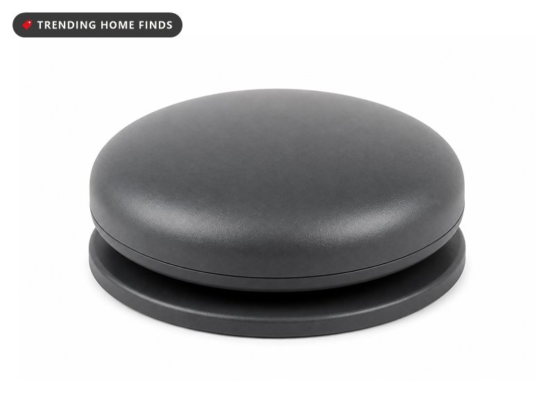 A small round dark gray wireless propane tank sensor puck with a flat magnetic base.