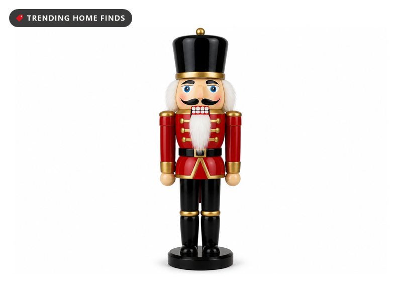 A red and black wooden toy soldier nutcracker with a tall black hat, white beard and round black base.