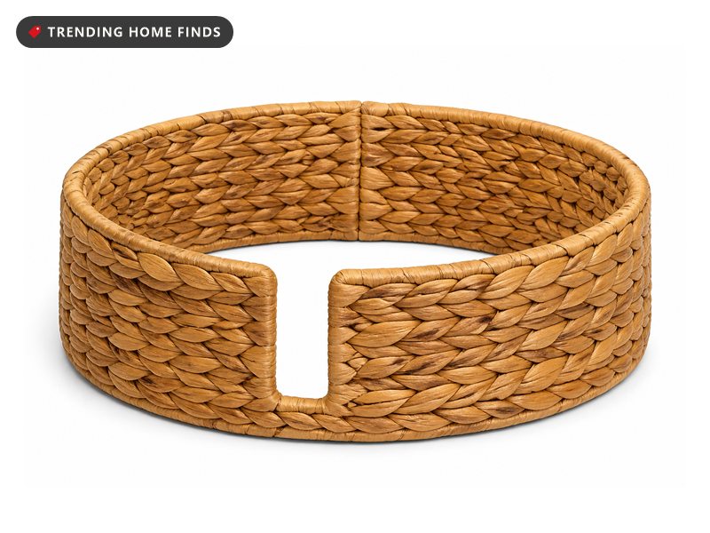 A low round woven water hyacinth tree collar in honey tones with a small cut out on one side.